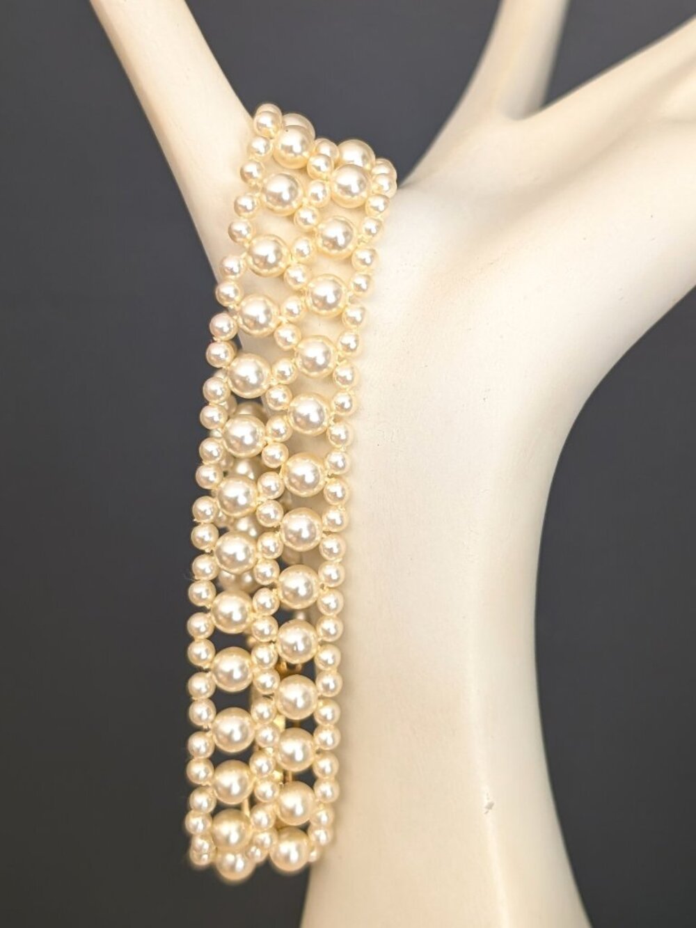 Faux pearl bracelet with gold tone fold over clasp